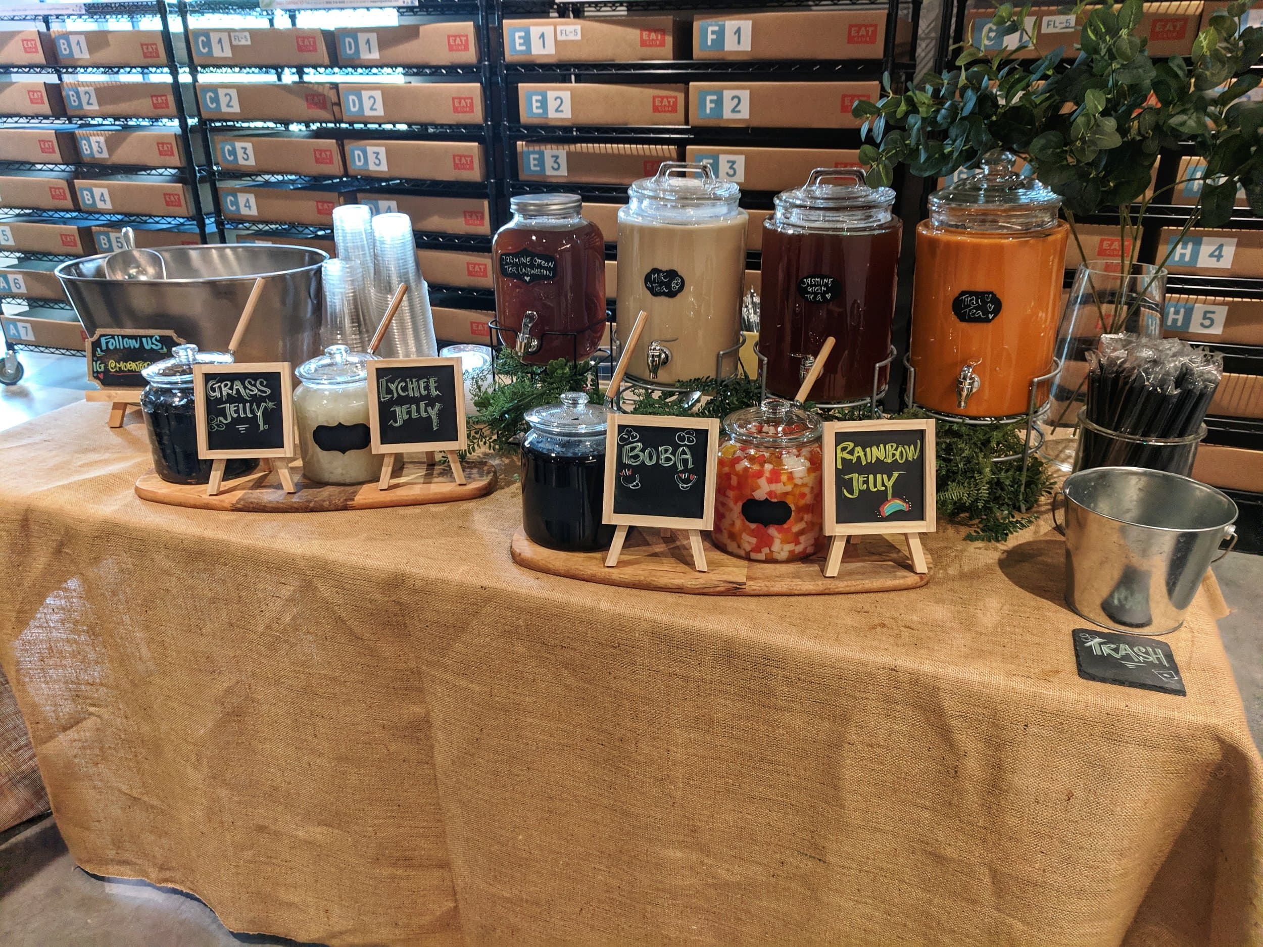 Wedding boba and cold brew tea bar setup with glass dispensers